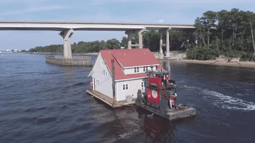 A floating home being tugged