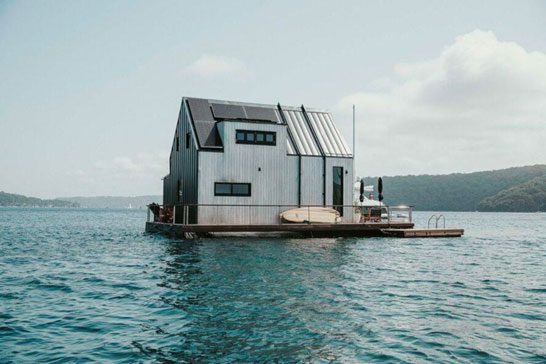 a floating house in ocean and mountain background