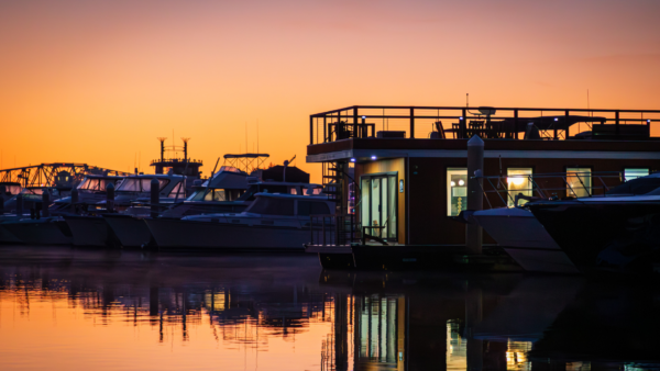 FLOHOM 15 Palmera luxury houseboat docked at Barefoot Landing Marina in North Myrtle Beach at sunrise with boats reflected on the Intracoastal Waterway.